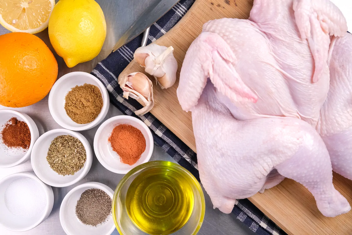 All the ingredients required to make the pollo asado measured and gathered on the table.
