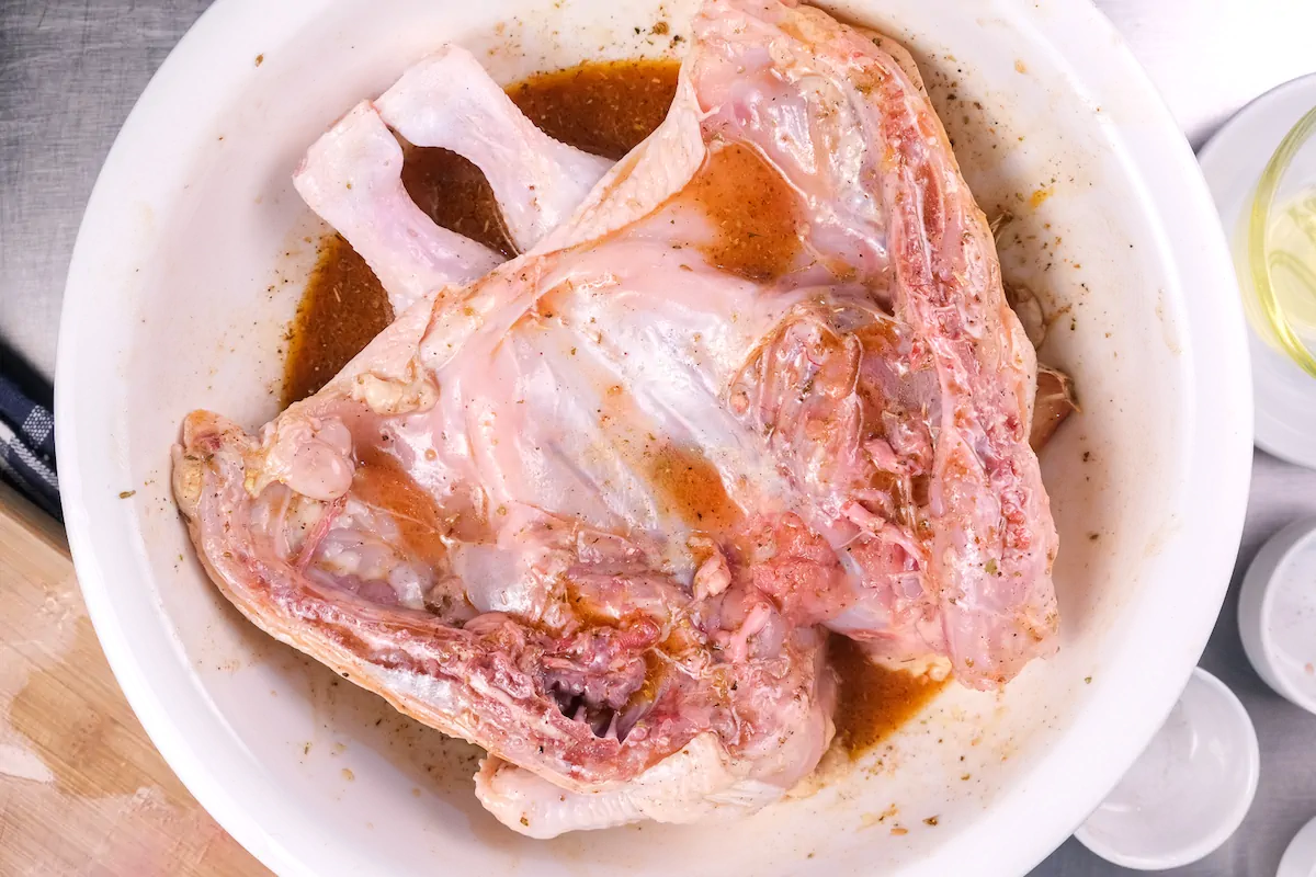 Chicken in a bowl with the marinade.