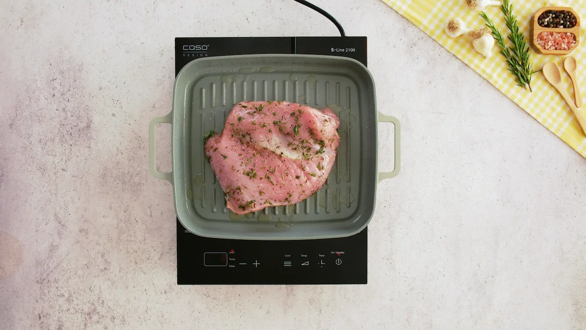 Searing the turkey breast on a grill pan.