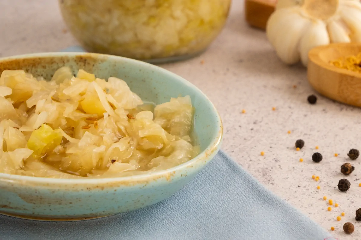 Focused picture of tangy pickled sauerkraut served in a ceramic bowl.