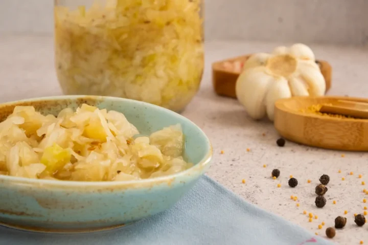Low-carb tangy pickled sauerkraut served in a ceramic bowl.