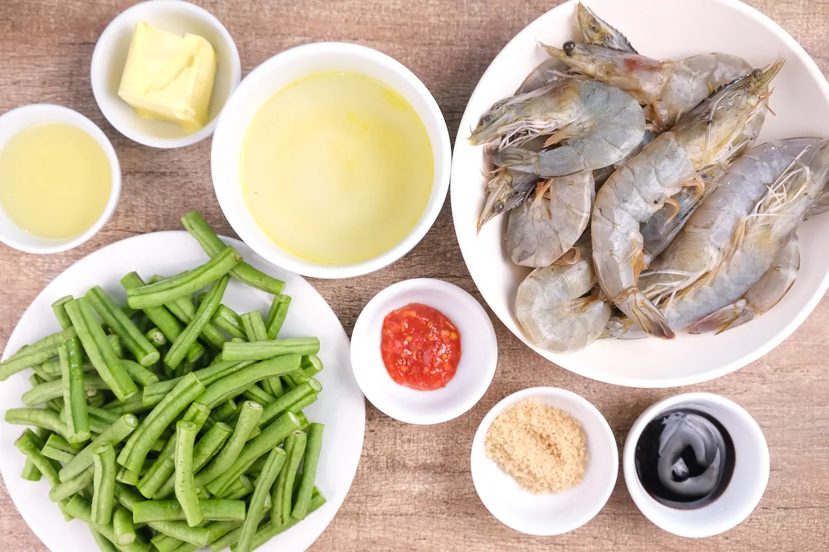 All the ingredients required to make this shrimp stir fry are gathered and measured on the table.