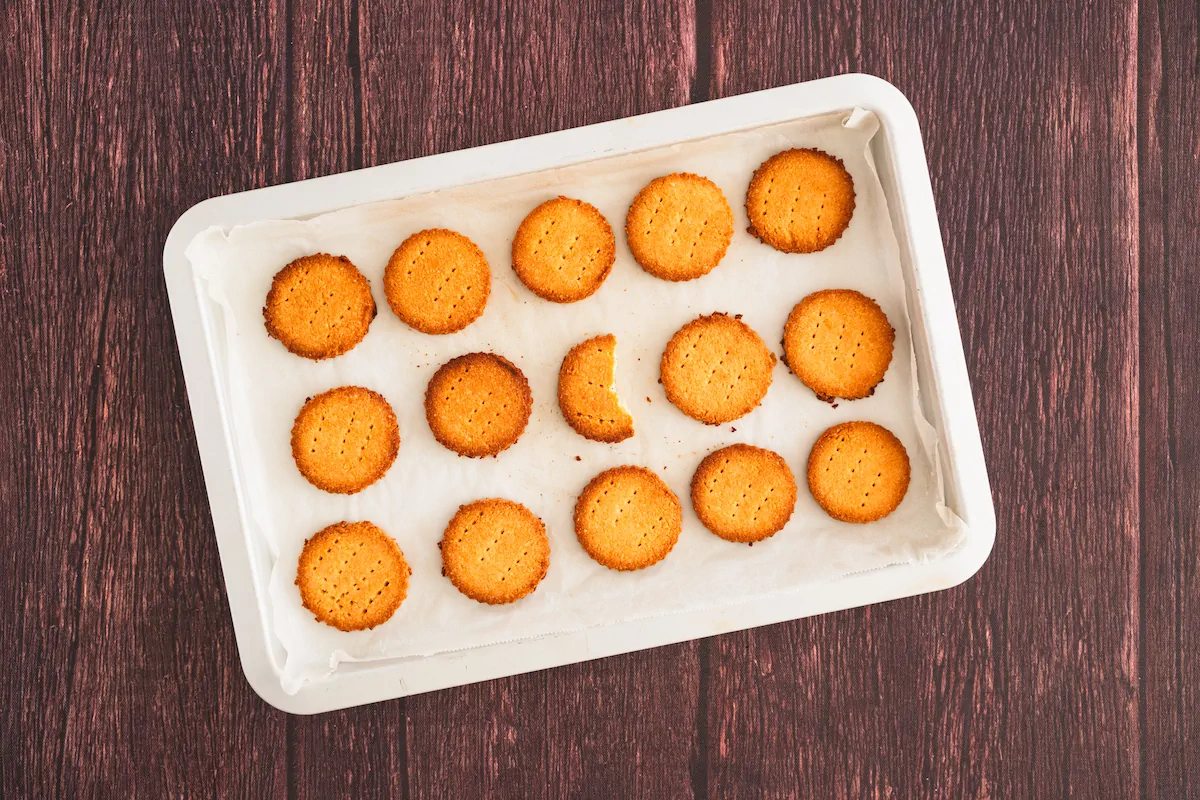 Freshly baked almond flour shortbread cookies on a white tray.