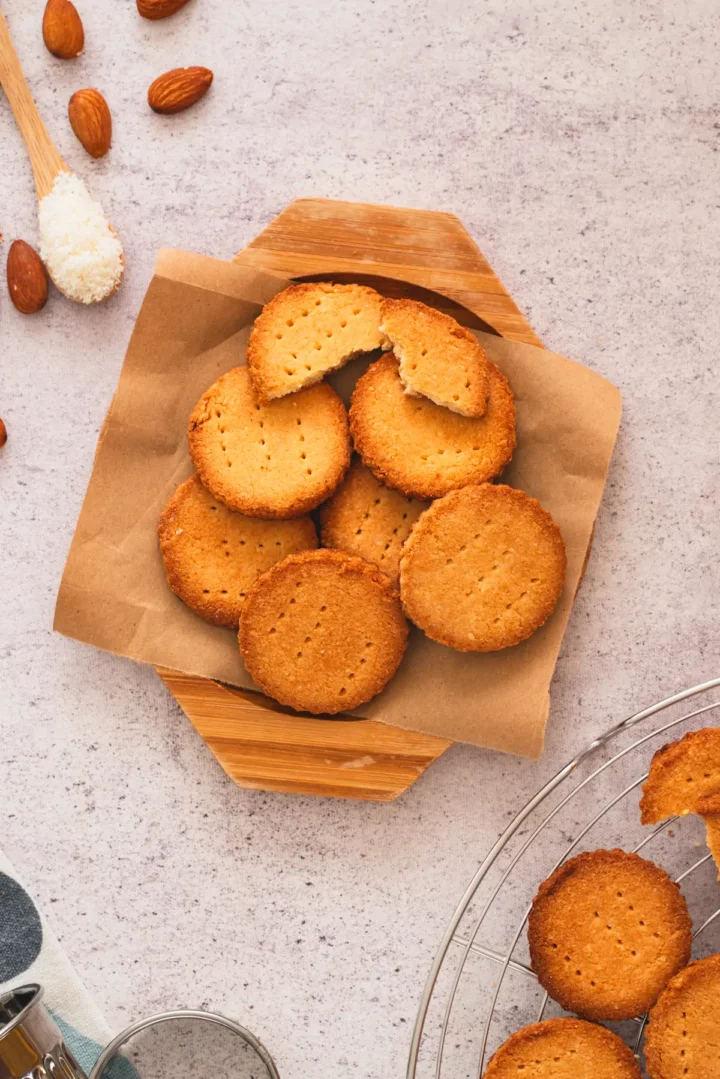 Freshly baked almond flour shortbread cookies on a wooden plate.