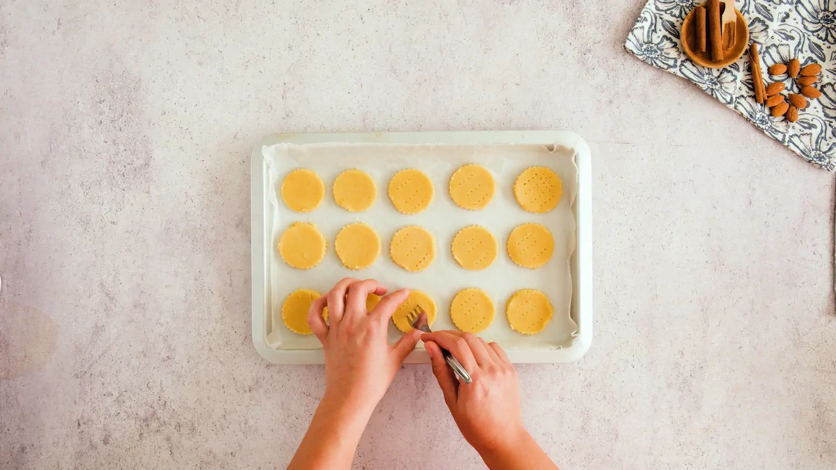 Pricking holes in the cut-out cookies on a tray before baking.