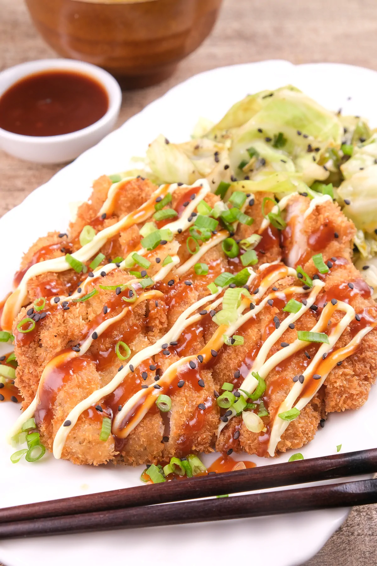 Slices of fried chicken fillets topped with Japanese mayonnaise and katsu sauce.