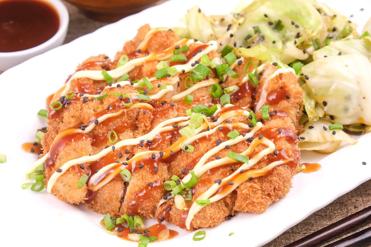 Slices of crispy chicken fillets with Japanese mayo and katsu sauce.