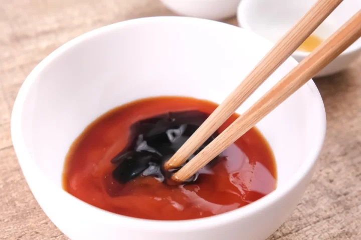 Mixing ketchup, oyster sauce, xylitol honey, and Worcestershire sauce in a bowl with a pair of chopsticks for the katsu sauce.