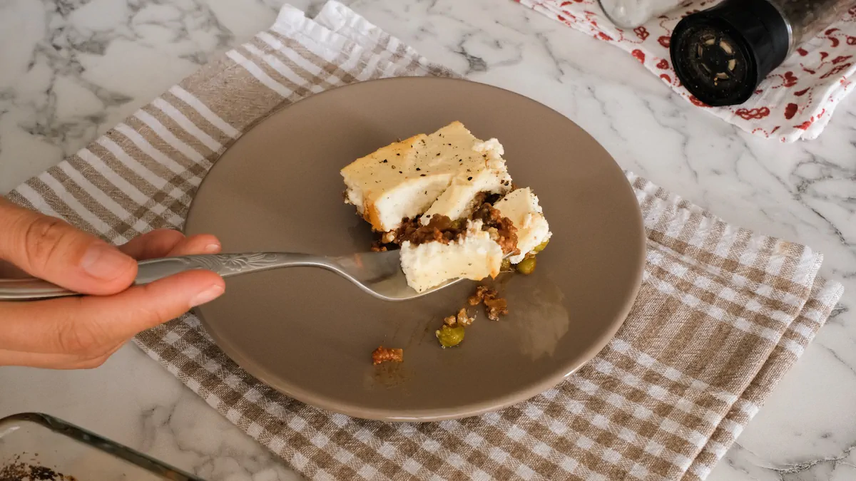 Keto cottage pie served on a plate, a portion on a fork.