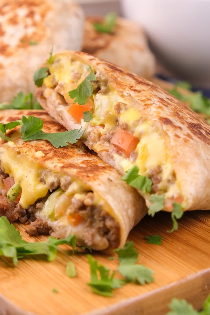 The up-close shot of keto crunchwrap sliced showing the filling of ground beef, cheese, and vegetables.