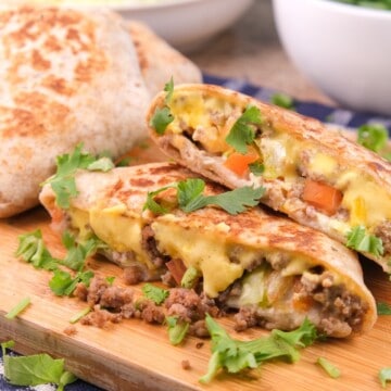 Homemade keto crunchwrap cut showing the filling of ground beef, cheese, and veggies.