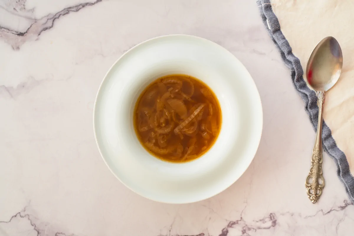 Homemade keto French onion soup served in a bowl with a spoon.