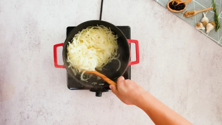 Cooking onion in a pot in an induction stovetop.