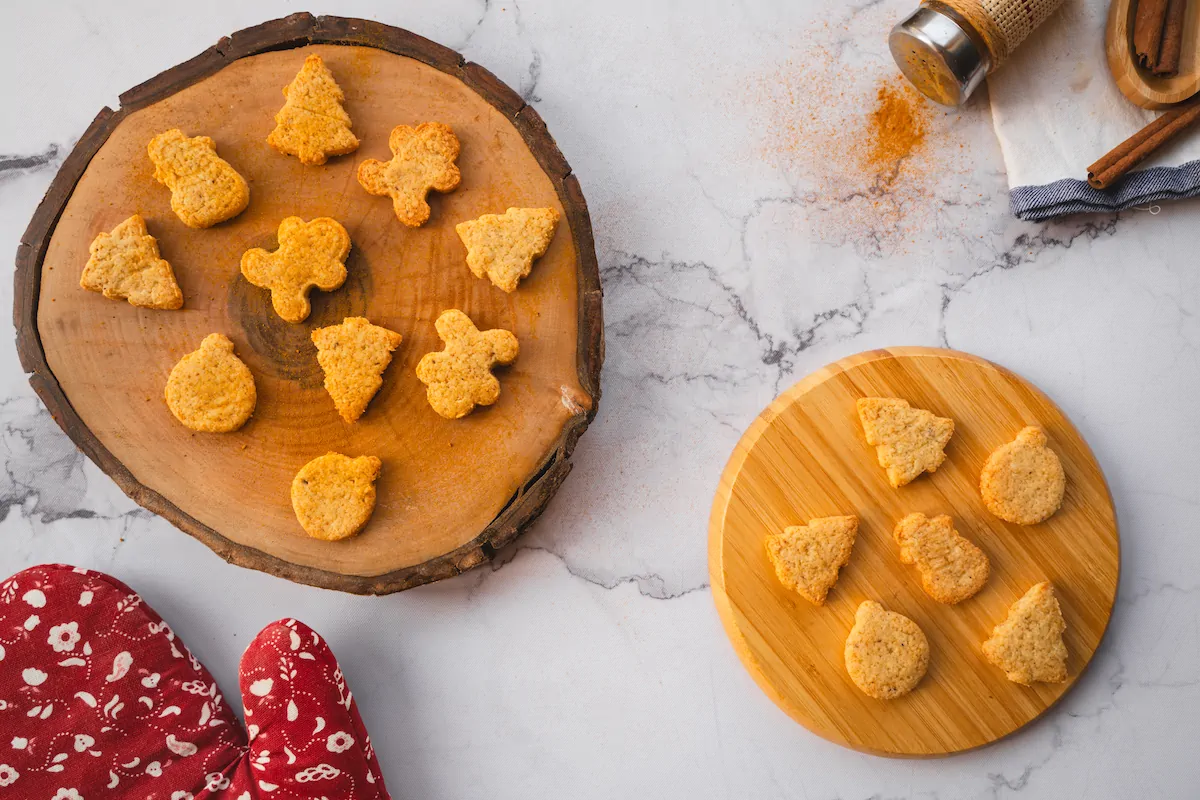 Keto gingerbread cookies presented on a wooden board.