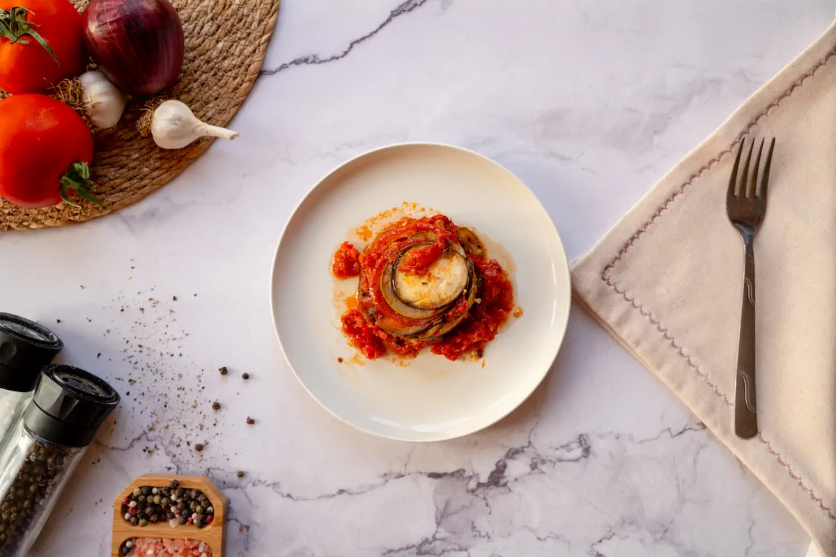 Homemade keto ratatouille served on a plate with a fork.