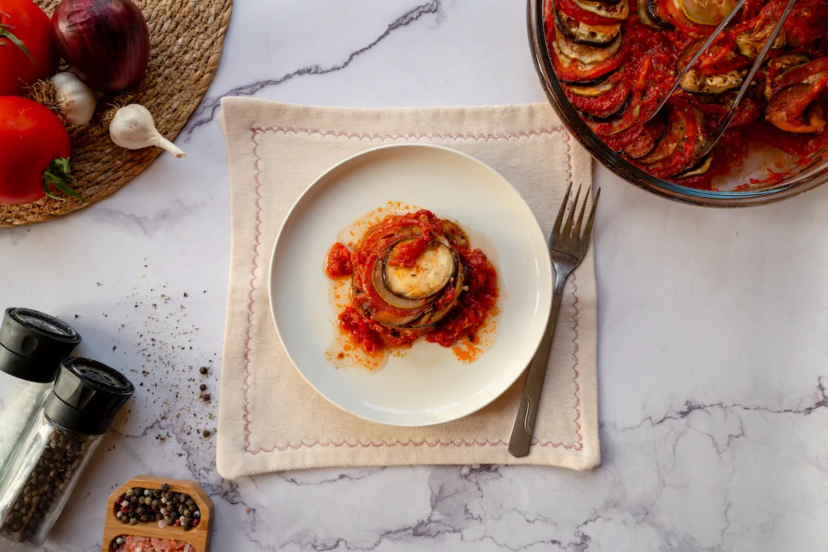Keto ratatouille served on a plate with a fork from the baking dish.