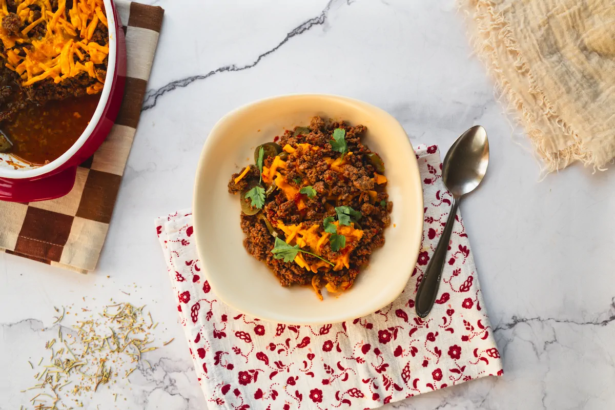 A bowl showcasing homemade keto Tex-Mex casserole, served alongside a spoon.