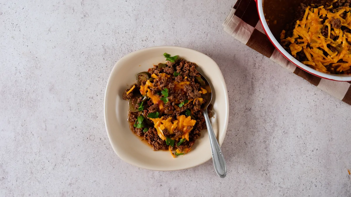 Keto Tex-Mex casserole served in a bowl and garnished with fresh herbs.