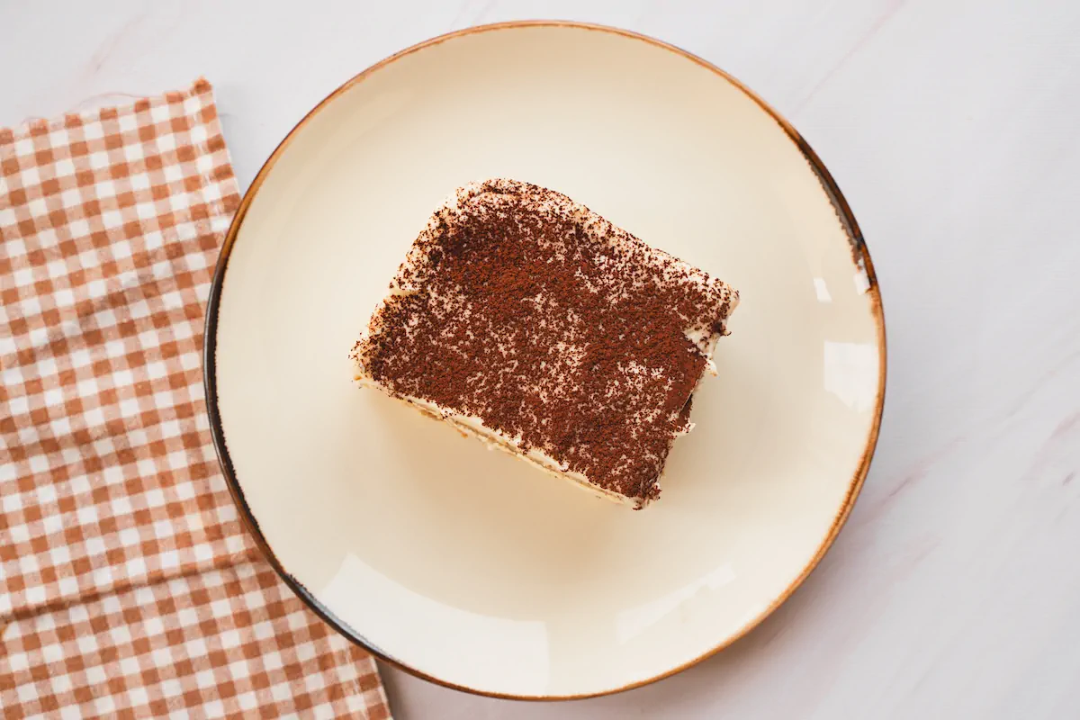 Keto tiramisu dusted with cocoa powder served on a plate.
