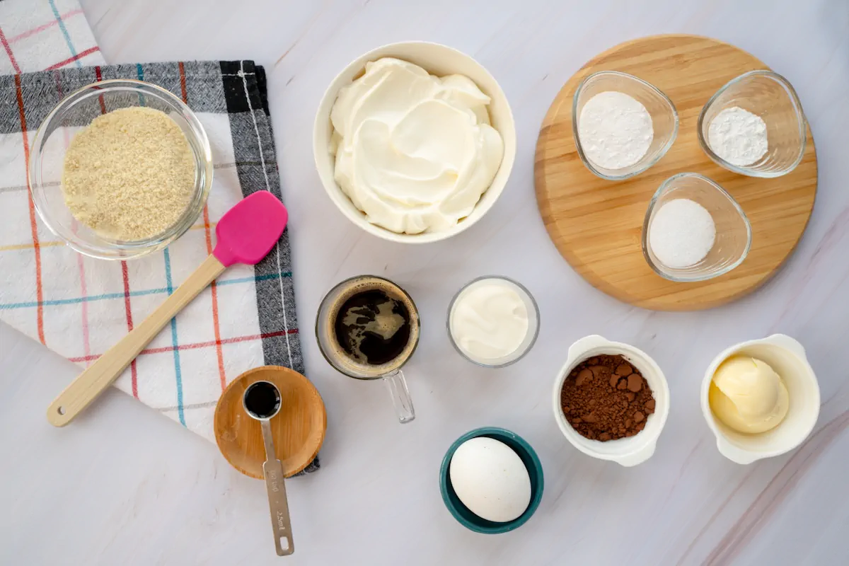 All the ingredients required to make keto tiramisu gathered and arranged on the table.