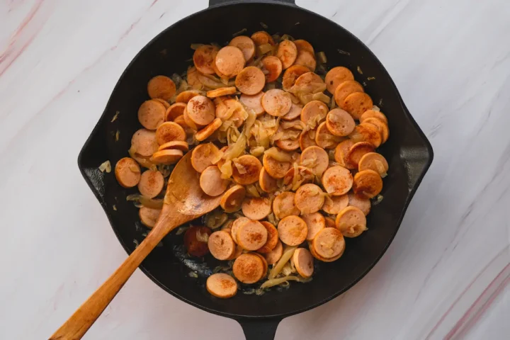 Sausage and sauerkraut in a cast iron skillet ready to be served.