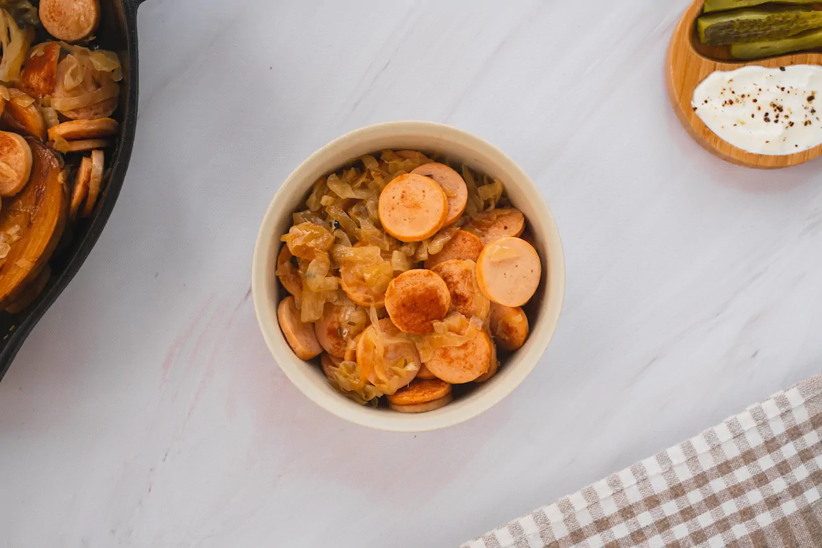 Sausage and sauerkraut served in a small bowl.
