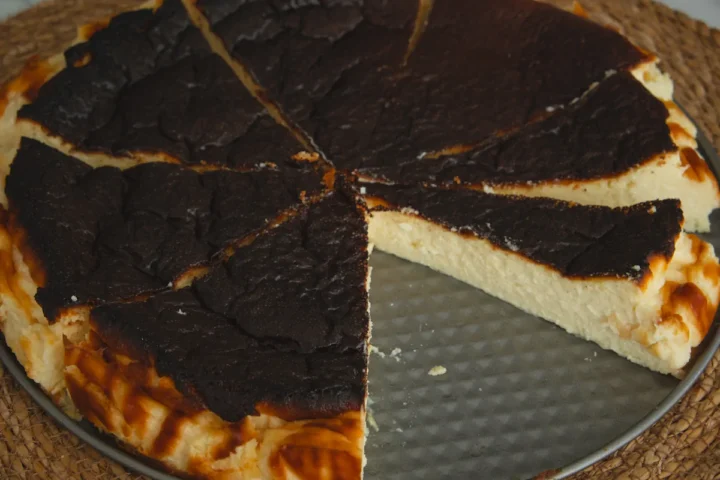 The whole sugar-free burnt Basque cheesecake sliced showing the textures.
