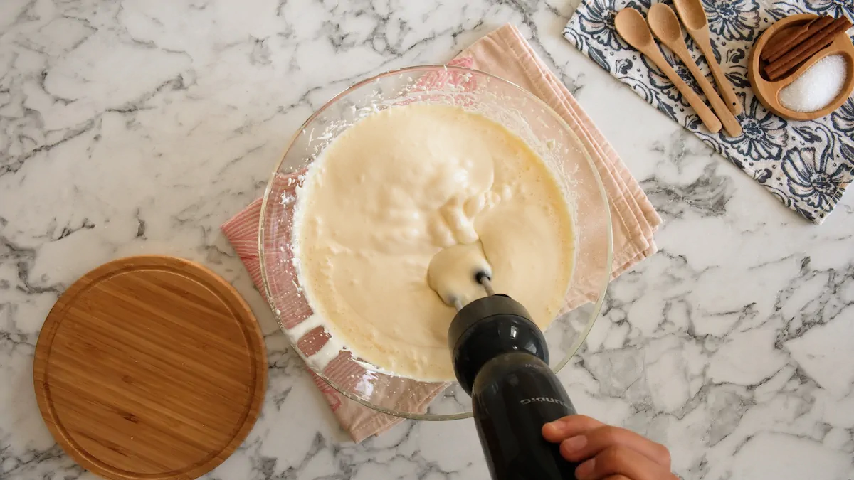 Mixing sugar-free cheesecake in a bowl with an electric hand mixture.