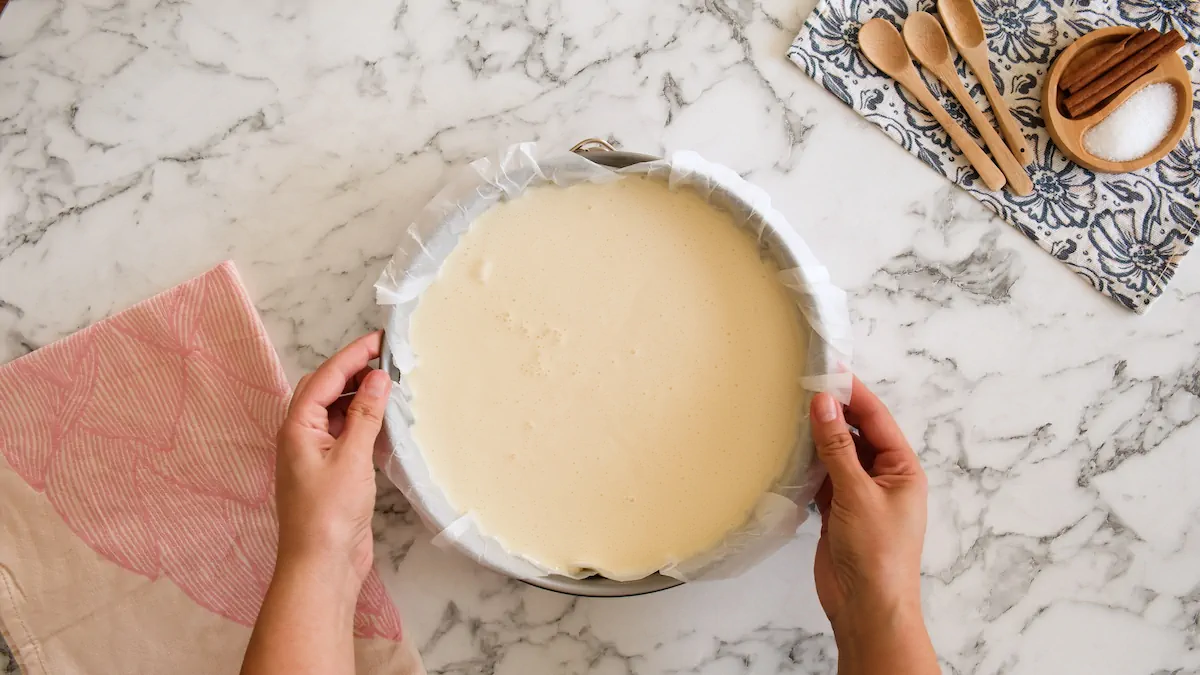 Cake mold with cheesecake batter ready to be baked.