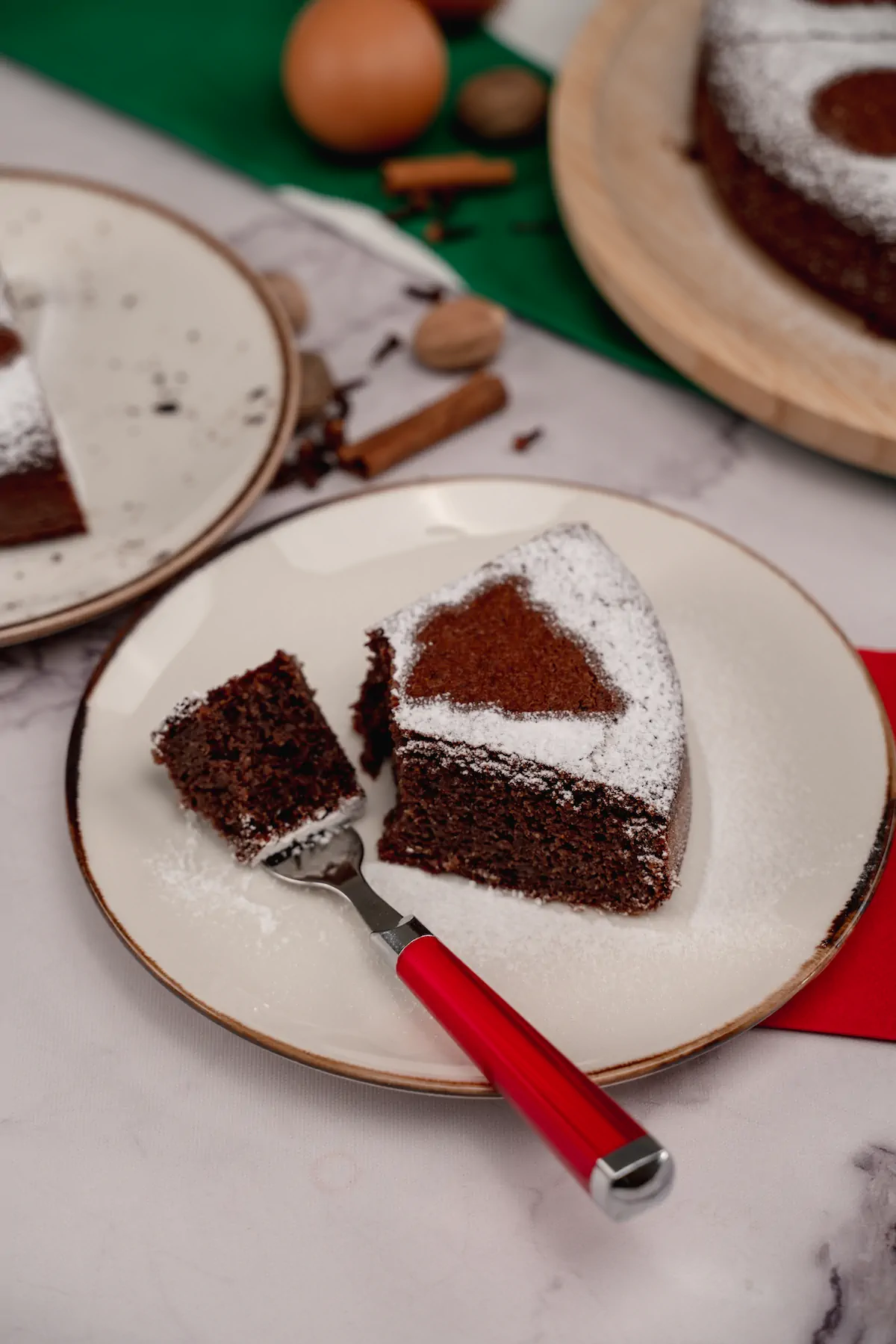 Sugar-free gingerbread cake on a plate, with a fork holding a bite.