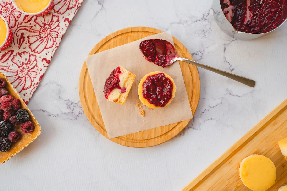 Homemade mini cheesecake bites adorned with keto-friendly raspberry jam.