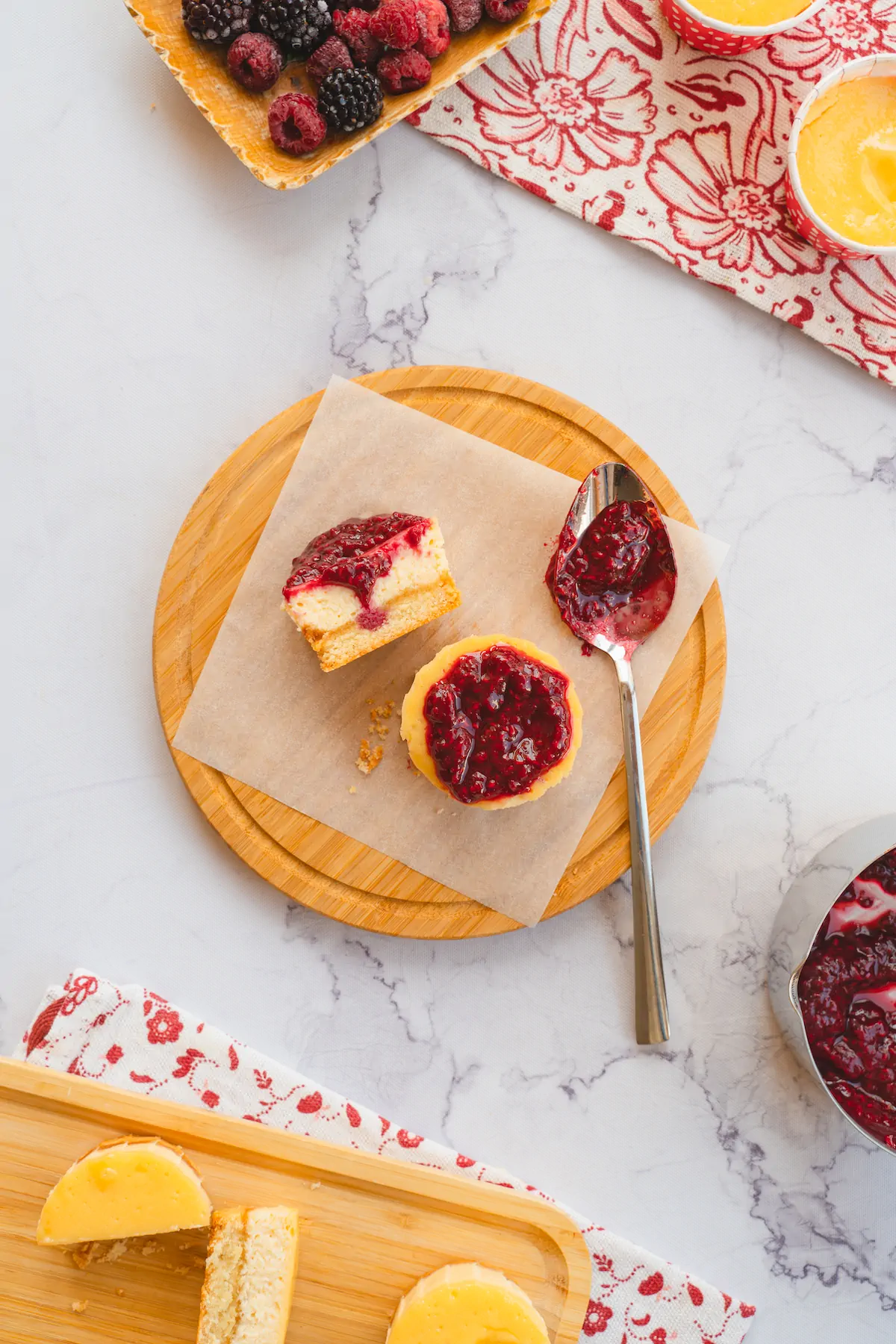 A topping of keto-friendly raspberry jam on mini cheesecake bites.