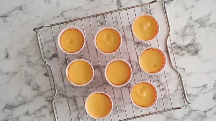 Cooling the baked mini cheesecake bites on a wire rack.