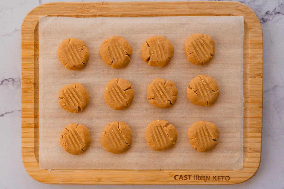 No-bake coconut cookies served on a wooden tray lined with parchment paper.