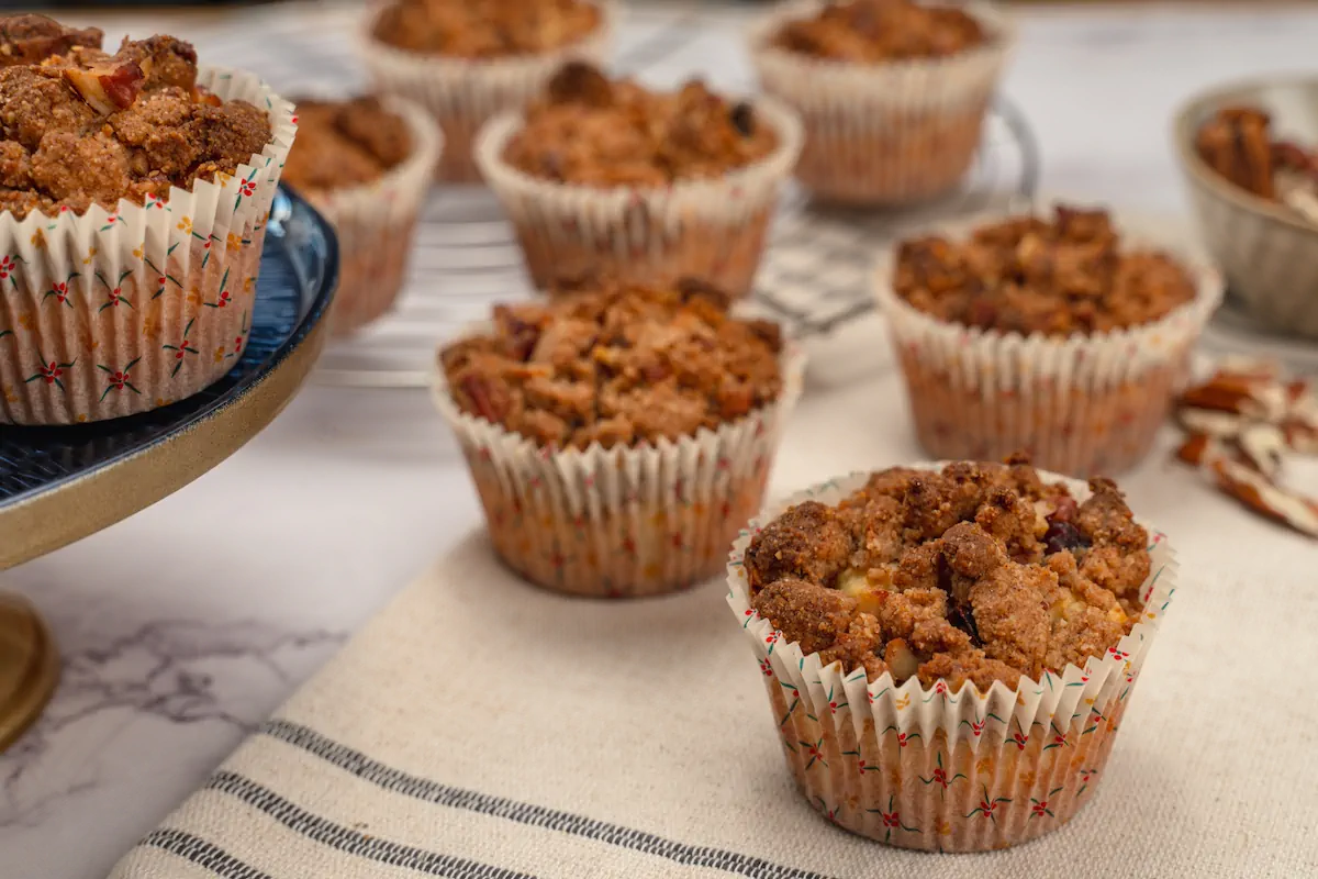 A focused image of a keto almond flour muffin and other such muffins in the background.