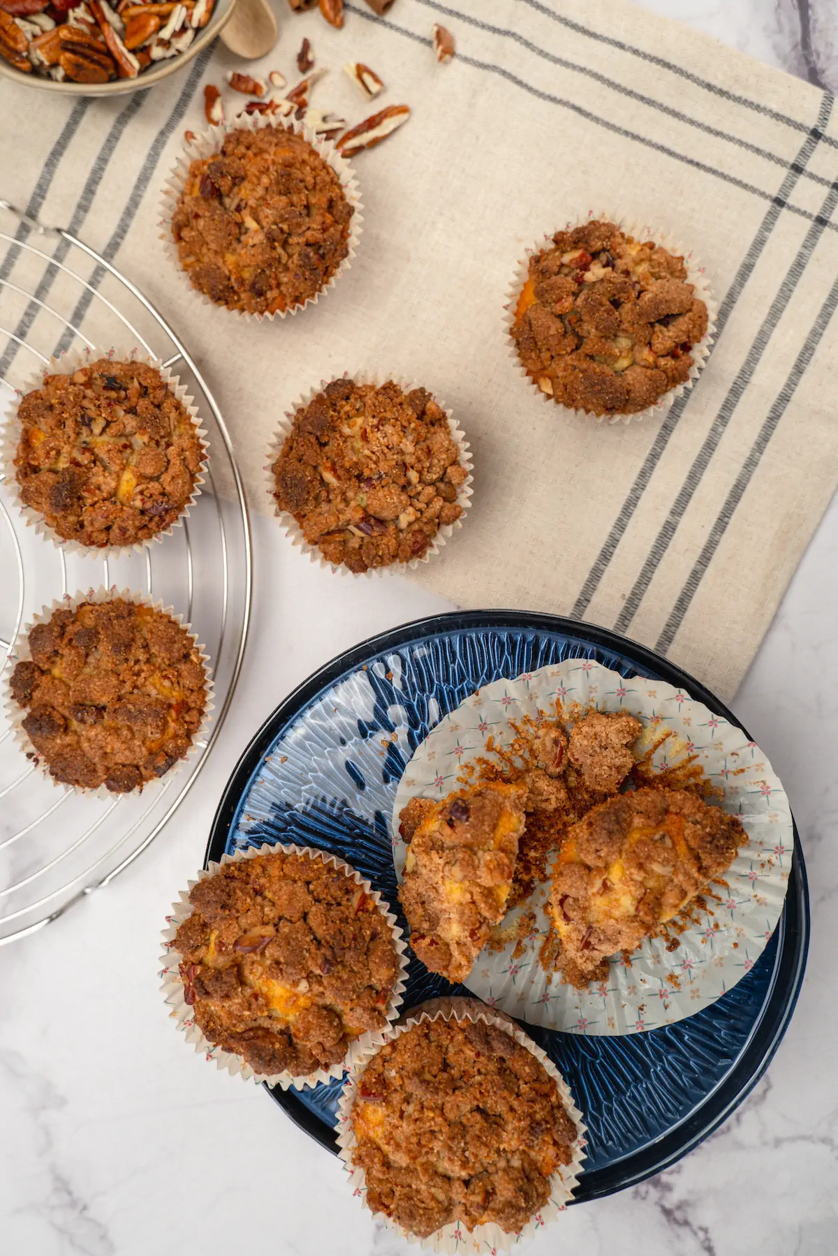A top shot of homemade keto almond flour muffins and some presented on a blue round plate.