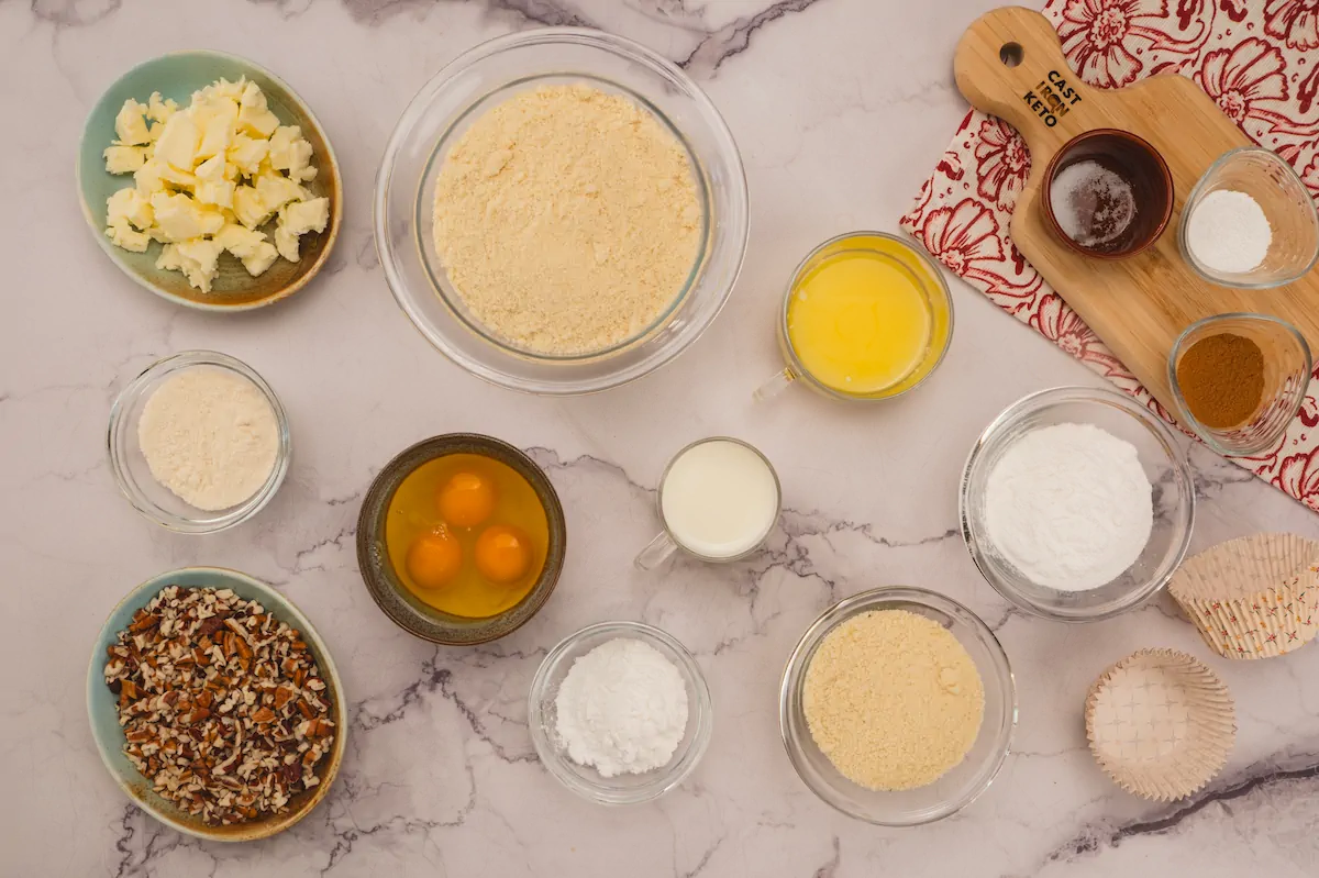 All the ingredients required to make keto almond flour muffins gathered and displayed on the table.